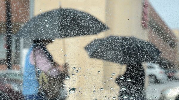 Люди с зонтами во время дождя. Архивное фото - Sputnik Кыргызстан