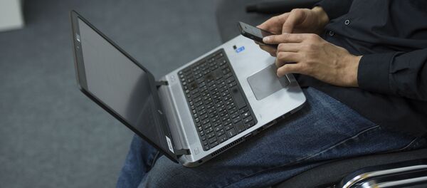 Мужчина с ноутбуком и мобильным телефоном. Архивное фото - Sputnik Кыргызстан