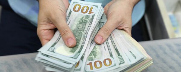 Мужчина считает доллары США. Архивное фото - Sputnik Кыргызстан
