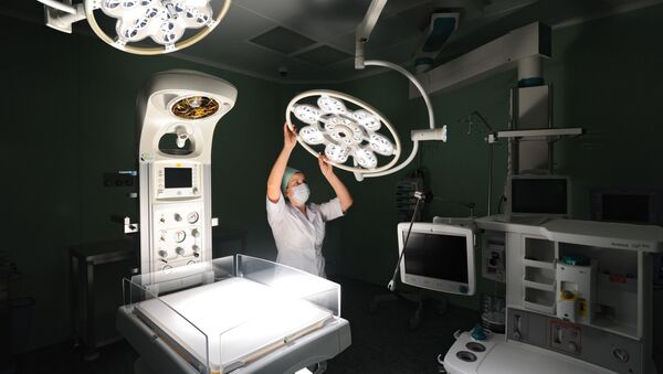 Медицинская сестра регулирует лампу в операционном отделении. Архивное фото - Sputnik Кыргызстан