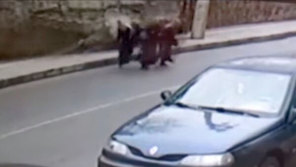 Женщины успели отбежать от рухнувшей стены в последний момент. Видео - Sputnik Кыргызстан