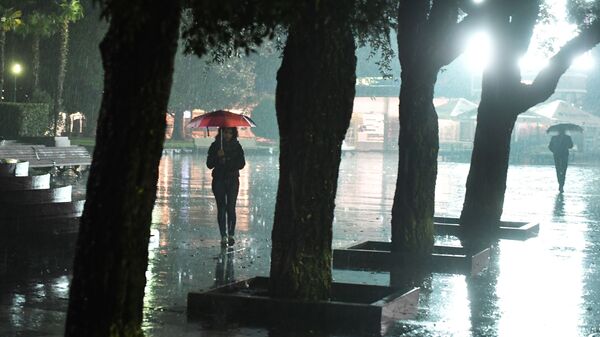 Прохожие на одной из улиц во время дождя. Архивное фото - Sputnik Кыргызстан