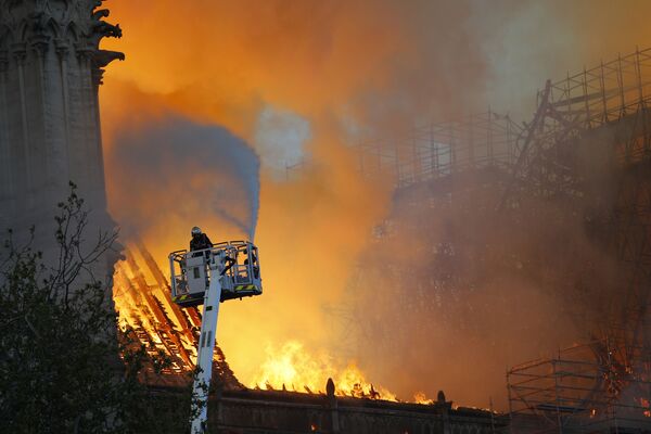 Пожарные во время тушения пожара в соборе Парижской Богоматери - Sputnik Кыргызстан