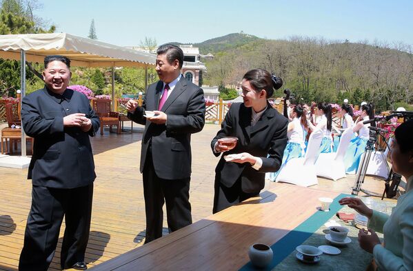 Лидер Северной Кореи Ким Чен Ын пьет чай с председателем КНР Си Цзиньпином в китайском городе Далянь - Sputnik Кыргызстан