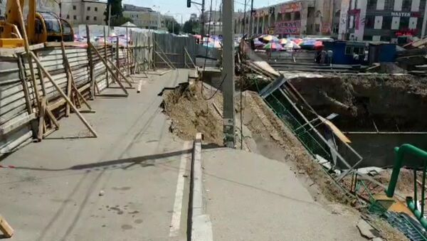 В котловину строящегося здания на Ошском рынке обрушился тротуар. Видео - Sputnik Кыргызстан
