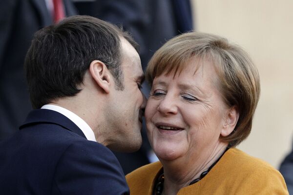 Президент Франции Эммануэль Макрон целует канцлера Германии Ангелу Меркель в Париже - Sputnik Кыргызстан