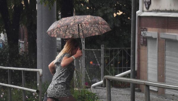 Девушка с зонтом идет по улице во время дождя. Архивное фото - Sputnik Кыргызстан