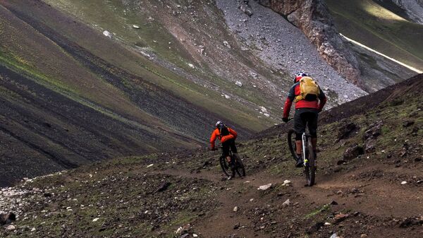 Путешественники едут на велосипедах по Алайским горам, Кыргызстан. Архивное фото - Sputnik Кыргызстан