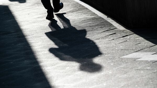 Мужчина отбрасывает длинную тень на тротуар. Архивное фото - Sputnik Кыргызстан
