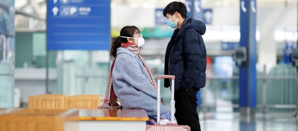 Молодой парень и девушка в медицинских масках в аэропорту. Архивное фото - Sputnik Кыргызстан