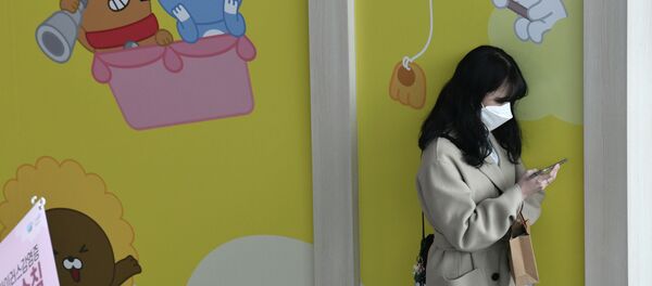 Медициналык бет капчан кыз смартфонду кармап турат. Архив - Sputnik Кыргызстан