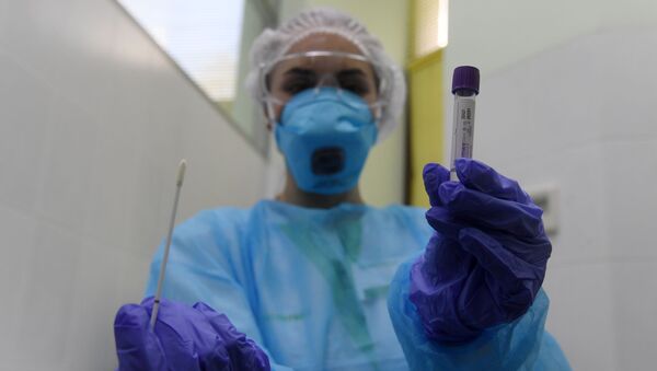 Пробирка с тестом на коронавирус в руках у сотрудницы в медицинской лаборатории. Архивное фото - Sputnik Кыргызстан