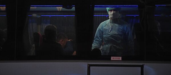 Сотрудник медицинской службы осматривает пассажиров автобуса. Архивное фото - Sputnik Кыргызстан