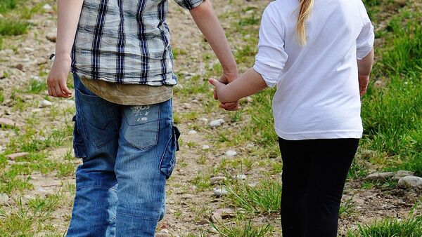 Мальчик и девочка идут держась за руки. Архивное фото - Sputnik Кыргызстан
