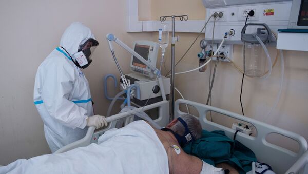 Медицинский работник возле кровати пациента в отделении реанимации. Архивное фото - Sputnik Кыргызстан