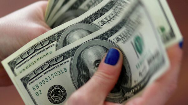 Женщина считает доллары США. Архивное фото - Sputnik Кыргызстан